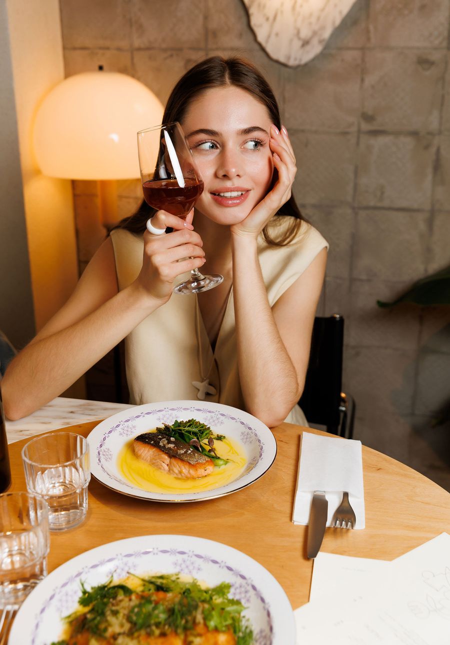 Guest with wine glass at dinner