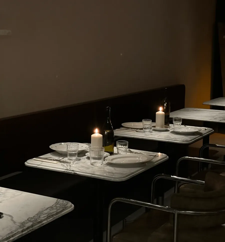 Marble tables with candles and wine glasses