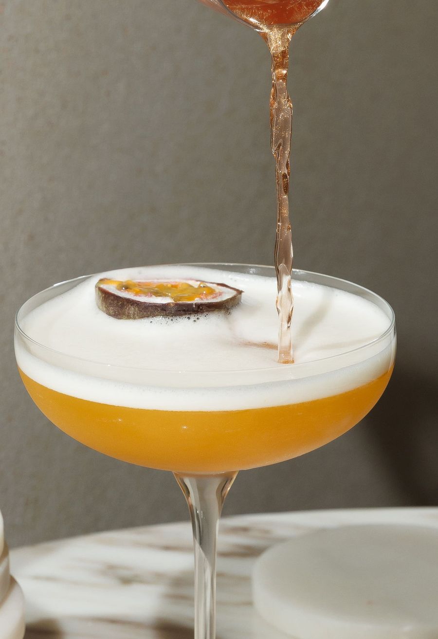 Passionfruit cocktail being poured